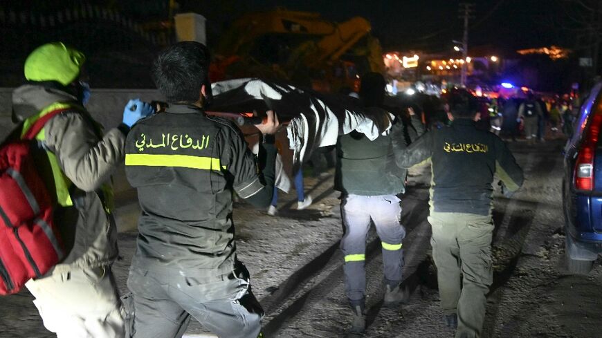 Rescuers carry a victim of an Israeli airstrike in the town of Aramoun, south of Beirut