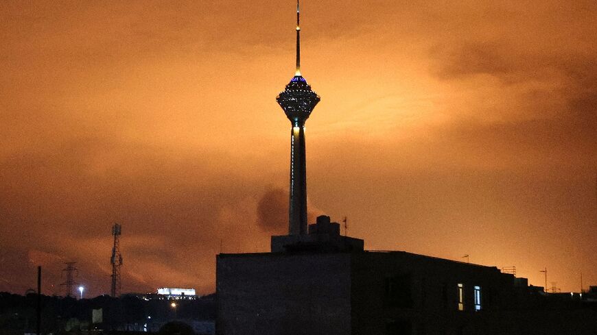 Skies around Tehran's Milad (Birth) Tower, the tallest tower in Iran, are lit up following airstrikes on March 7, 2026
