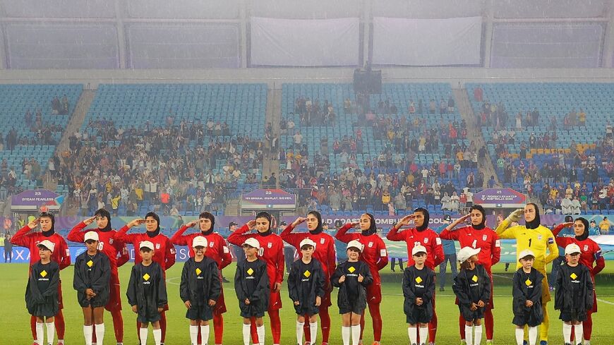 Iranian players salute during the national anthem before their AFC Women's Asian Cup match against the Philippines in Gold Coast