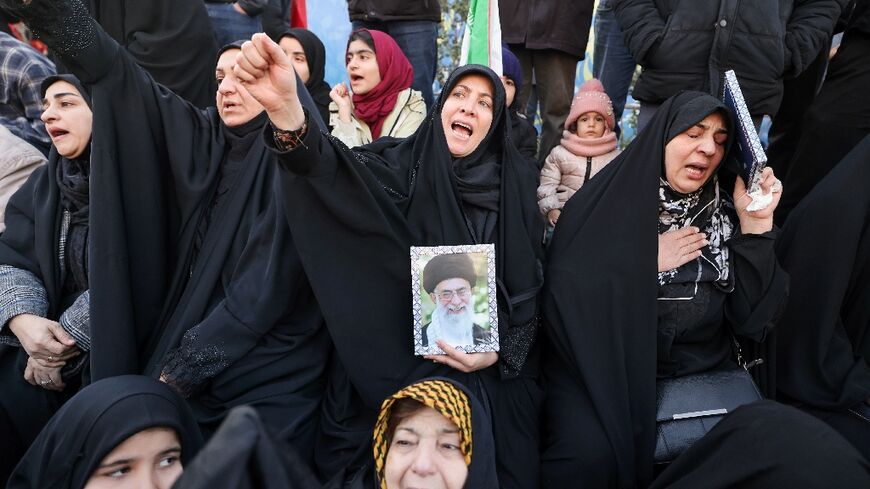 People mourn the death of Iran's supreme leader Ayatollah Ali Khamenei at a square in Tehran