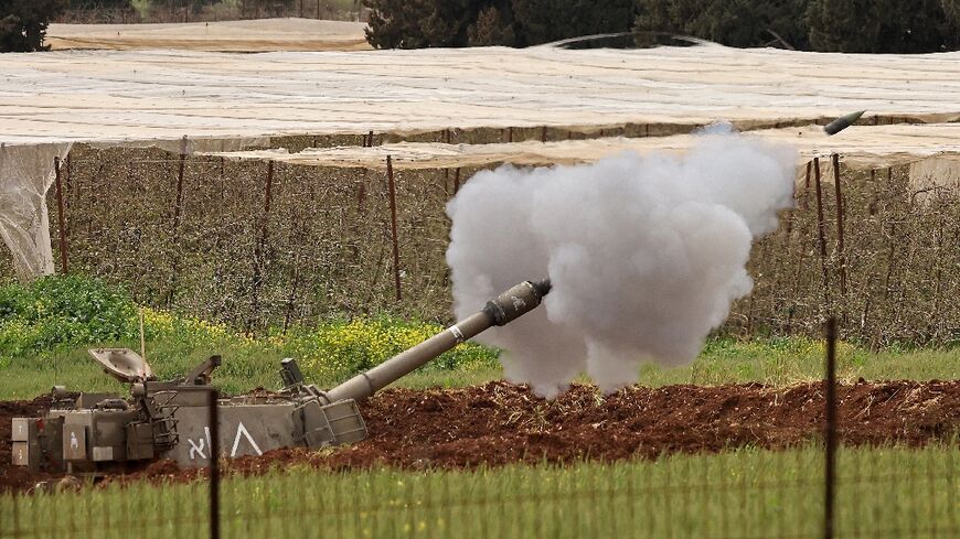 An Israeli self-propelled howitzer artillery gun fires rounds towards the southern Lebanon 