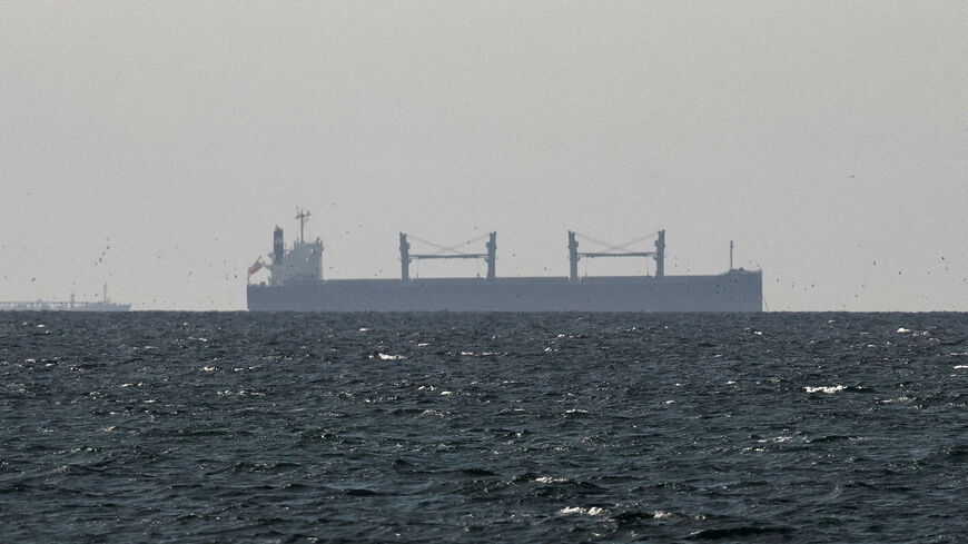 FILE PHOTO: A cargo ship in the Gulf, near the Strait of Hormuz, as seen from northern Ras al-Khaimah, near the border with Oman’s Musandam governance, amid the U.S.-Israeli conflict with Iran, in United Arab Emirates, March 11, 2026. REUTERS/Stringer/File Photo