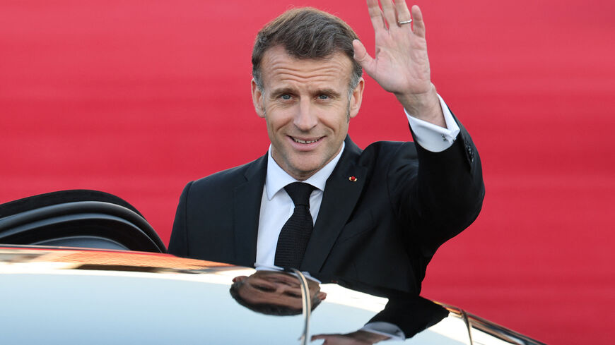 French President Emmanuel Macron waves to media as he leave Seoul Air Base in Seongnam, South Korea, April 2, 2026.    Yonhap via REUTERS