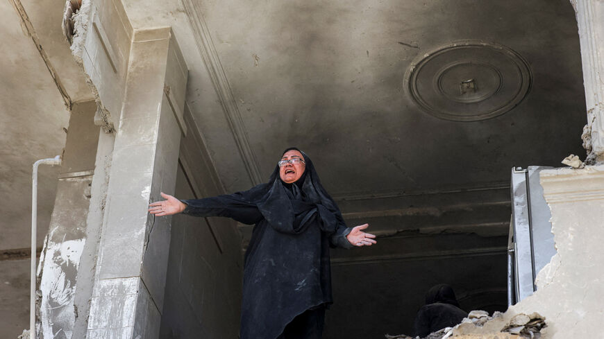 A woman reacts inside her brother's home, which was damaged by an airstrike, in Tehran, Iran, March 30.  Majid Asgaripour/WANA