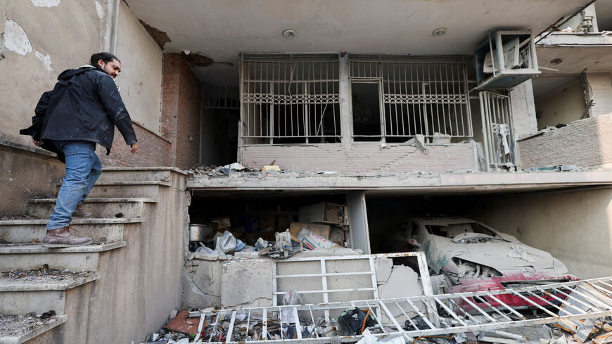 FILE PHOTO: An Iranian man, Parsa, goes into his house, which was destroyed by a strike, amid the U.S.-Israeli conflict with Iran, in Tehran, Iran, March 14, 2026. REUTERS/Alaa Al Marjani/File Photo
