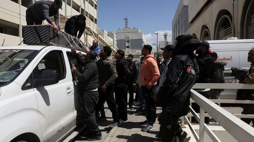 People place a coffin of a person killed in an Israeli strike on Wednesday, on top of a vehicle, at Rafik Hariri University Hospital in Beirut, Lebanon, April 9, 2026. REUTERS/Emilie Madi