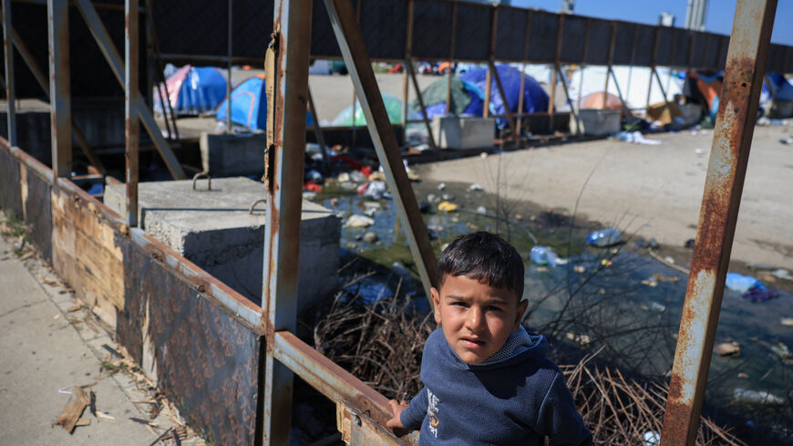 A child looks on at the makeshift encampment, by people who fled their homes after Israeli evacuation orders, in Beirut, Lebanon, April 8, 2026. REUTERS/Louisa Gouliamaki