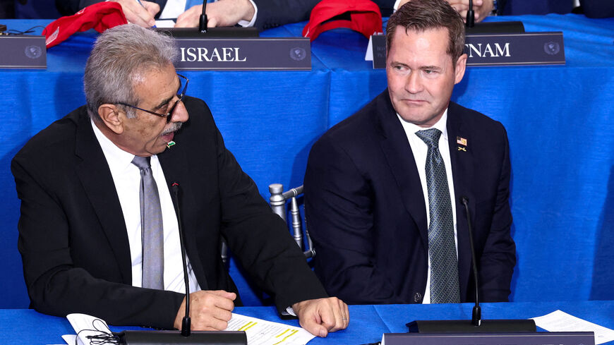 FILE PHOTO: U.S. Ambassador to the United Nations Mike Waltz and Chair of the Palestinian National Committee for the Administration of Gaza, Ali Shaath attend the inaugural Board of Peace meeting at the U.S. Institute of Peace in Washington, D.C., U.S., February 19, 2026. REUTERS/Kevin Lamarque/File Photo