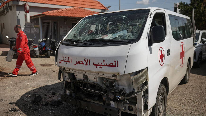 A staff member walks past a damaged Lebanese Red Cross vehicle after a drone strike damaged vehicles and a building, slightly injuring three workers, in Tyre, Lebanon, April 13, 2026. REUTERS/Louisa Gouliamaki