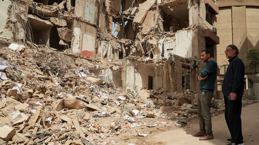 Wael and Ali Sabbagh, whose mother Afaf Sidaoui and brother Hassan were killed in an Israeli strike on an apartment building on April 8, stand at the strike site in Tallet El Khayat in Beirut, Lebanon, April 15, 2026. REUTERS/Jihed Abidellaoui