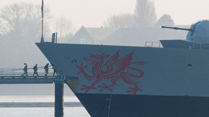 FILE PHOTO: Crew members board the HMS Dragon during ammunitioning operations at Upper Harbour Ammunitioning Facility (UHAF) in Portsmouth Harbour, after British Prime Minister Keir Starmer announced that Britain would deploy the naval vessel, along with helicopters equipped with counter-drone capabilities, to the eastern Mediterranean as the conflict in the Middle East intensifies, in Portsmouth, Britain, March 4, 2026. REUTERS/Carlos Jasso/File Photo