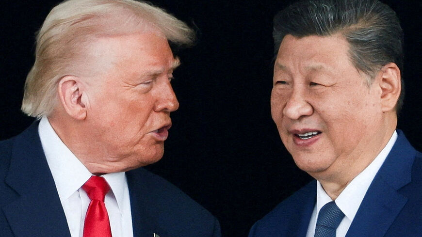 FILE PHOTO: U.S. President Donald Trump and Chinese President Xi Jinping talk as they leave after a bilateral meeting at Gimhae International Airport, on the sidelines of the Asia-Pacific Economic Cooperation (APEC) summit, in Busan, South Korea, October 30, 2025. REUTERS/Evelyn Hockstein/File Photo