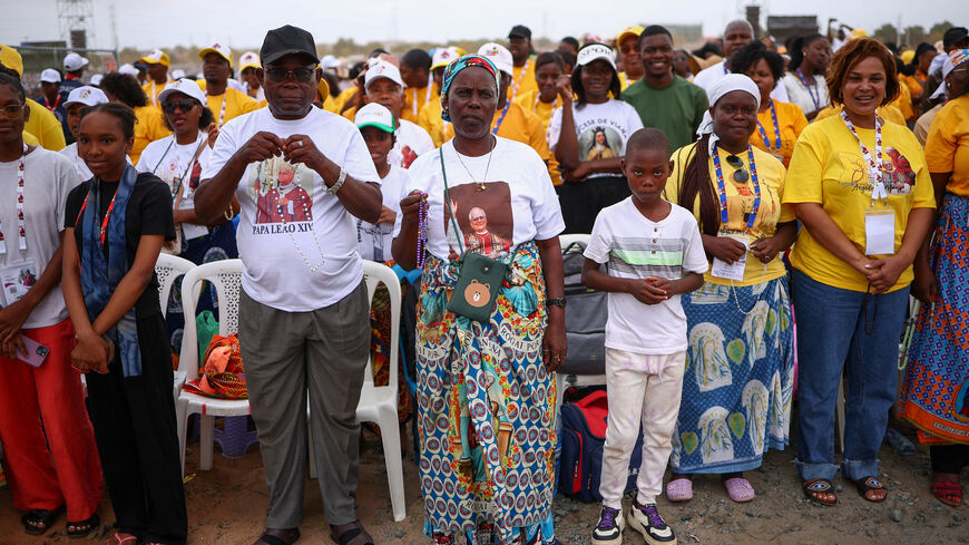 Faithful wait on the day Pope Leo XIV is to lead a Holy Mass, during his apostolic journey in Africa, in Kilamba, Luanda province, Angola, April 19, 2026. REUTERS/Guglielmo Mangiapane