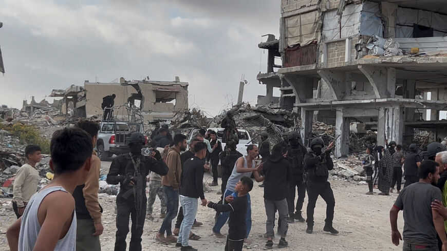 People react near Palestinians fighters after clashes with Israeli-backed militia, in Khan Younis, in the southern Gaza Strip, April 20, 2026, in this screengrab obtained from a video. Video obtained by REUTERSy.