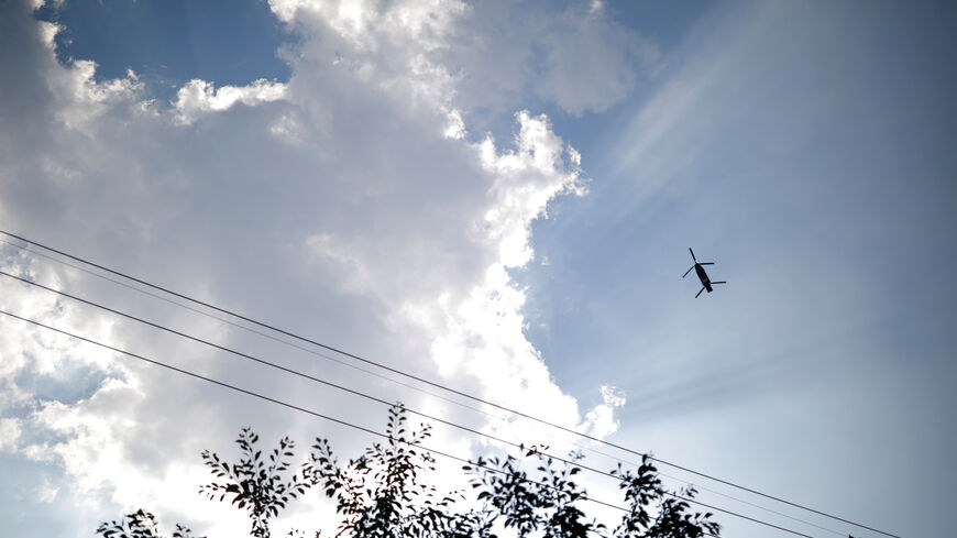 FILE PHOTO: A military helicopter carrying a container flies toward a golf course where a Terminal High Altitude Area Defense (THAAD) system is deployed, in Seongju, South Korea, June 14, 2017.  REUTERS/Kim Hong-Ji/File Photo