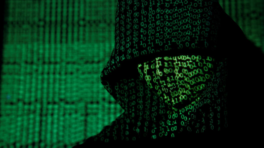 A projection of cyber code on a hooded man is pictured in this illustration picture taken on May 13,  2017. REUTERS/Kacper Pempel/Illustration/File Photo