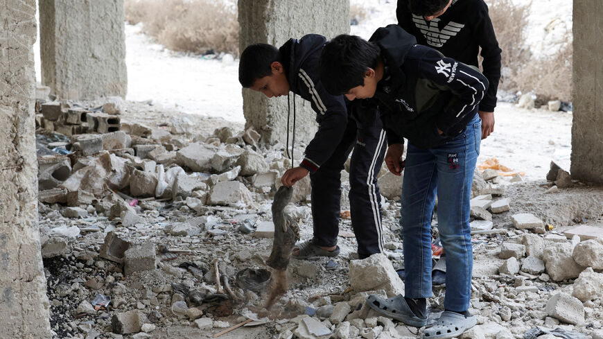 FILE PHOTO: Kids search and inspect bones amidst rubbles in Tadamon district, which is littered with bones after what residents and rights groups described as years of killings there under the rule of Syria's Bashar al-Assad, following al-Assad's ousting by fighters of the ruling Syrian body, in Damascus, Syria, December 12, 2024. REUTERS/Amr Abdallah Dalsh/File Photo