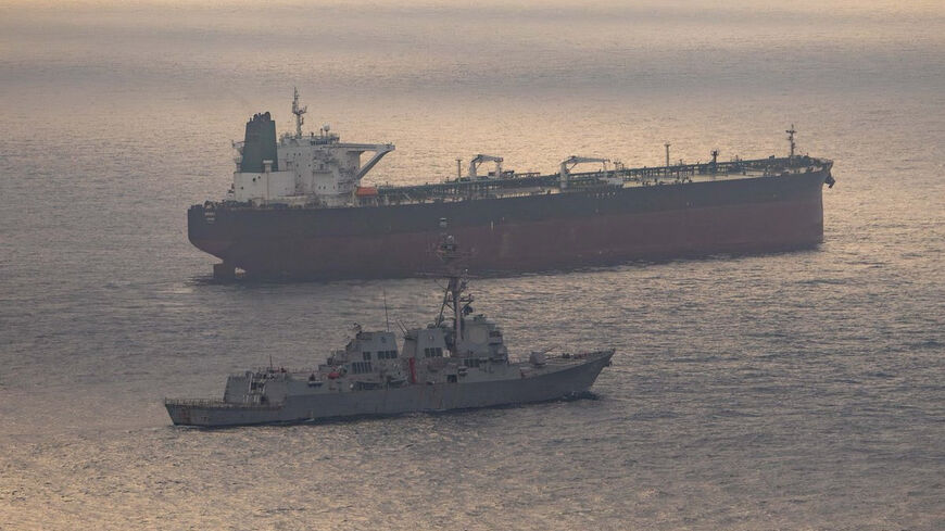 USS Rafael Peralta (DDG 115) near what the U.S. Central Command said was a vessel attempting to sail to an Iranian port, as it enforces the U.S. blockade on Iranian ports, at an unknown location, released April 24, 2026.   U.S. Central Command/Handout via REUTERS