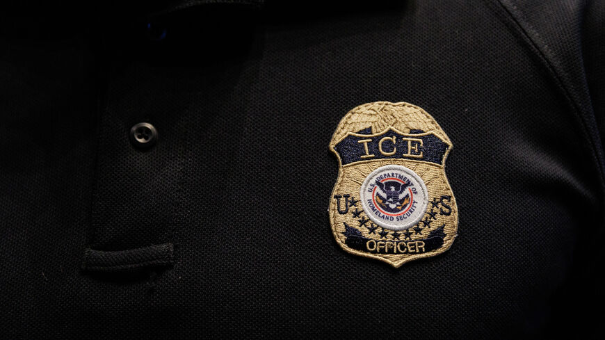 The badge of a U.S. Immigration and Customs Enforcement (ICE) is embroidered on a polo shirt of an ICE employee, in Arlington, Texas, U.S. August 26, 2025.  REUTERS/Shelby Tauber/File Photo