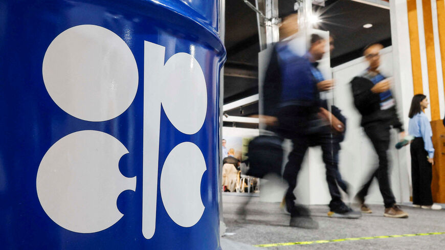 FILE PHOTO: People walk past an installation depicting barrel of oil with the logo of Organization of the Petroleum Exporting Countries (OPEC) during the COP29 United Nations climate change conference in Baku, Azerbaijan November 19, 2024. REUTERS/Maxim Shemetov/File Photo