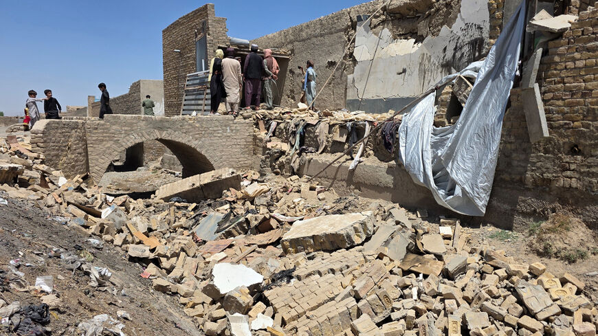 People stand on the rubble of a damaged building that, according to locals residents was damaged in a cross-border shelling by Afghanistan, in Chaman, Balochistan Province, Pakistan, April 28, 2026. Picture taken with a mobile phone. REUTERS/Abdul Khaliq Achakzai
