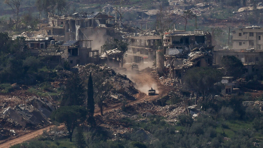 An Israeli military vehicle drives past destroyed buildings in Lebanon, as seen from the Israeli side of the Israel-Lebanon border, April 30, 2026. REUTERS/Shir Torem