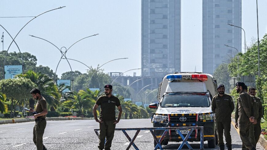 Security personnel keep watch near the expected venue of the US-Iran talks in the Red Zone area of Islamabad