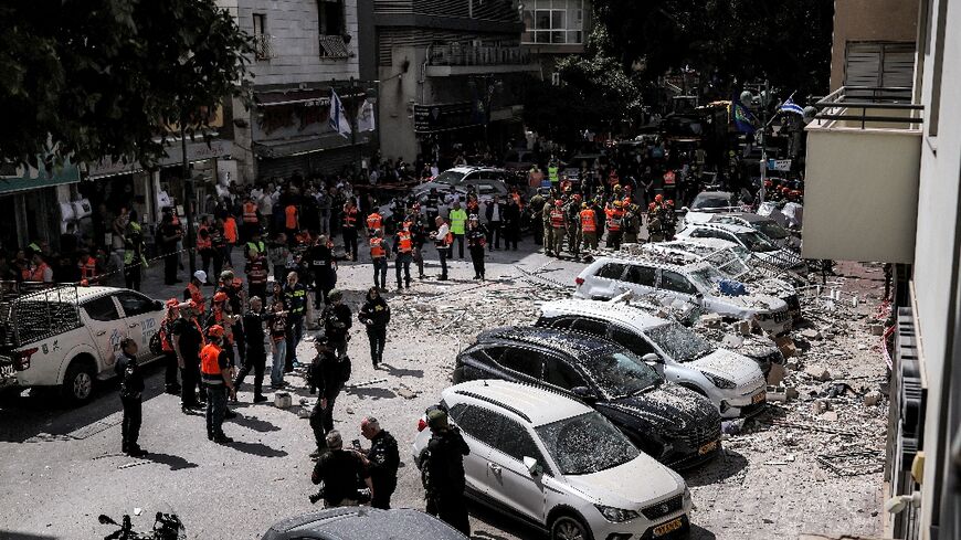 First responders next to a building hit by an Iranian strike in Ramat Gan, central Israel