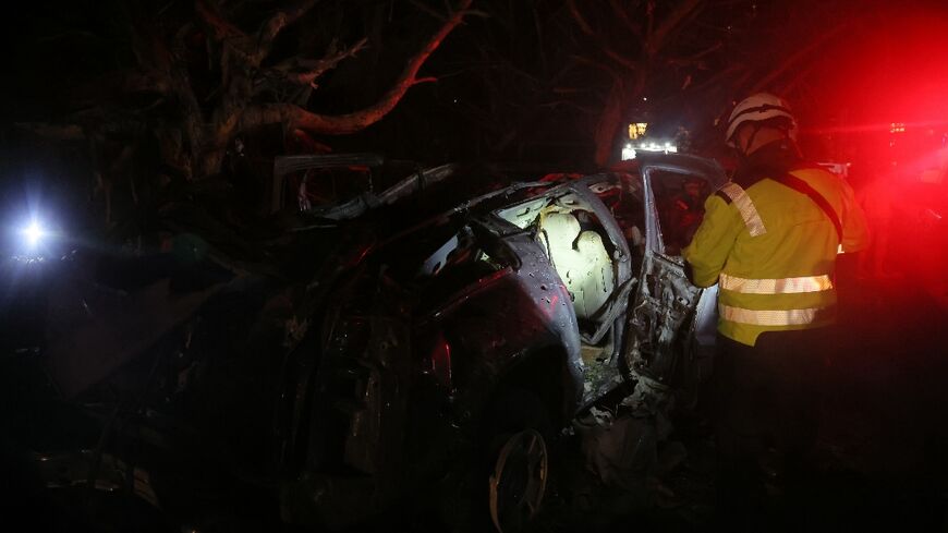 First responders at the site of Israeli strikes in al-Jnah on the outskirts of Beirut's southern suburbs