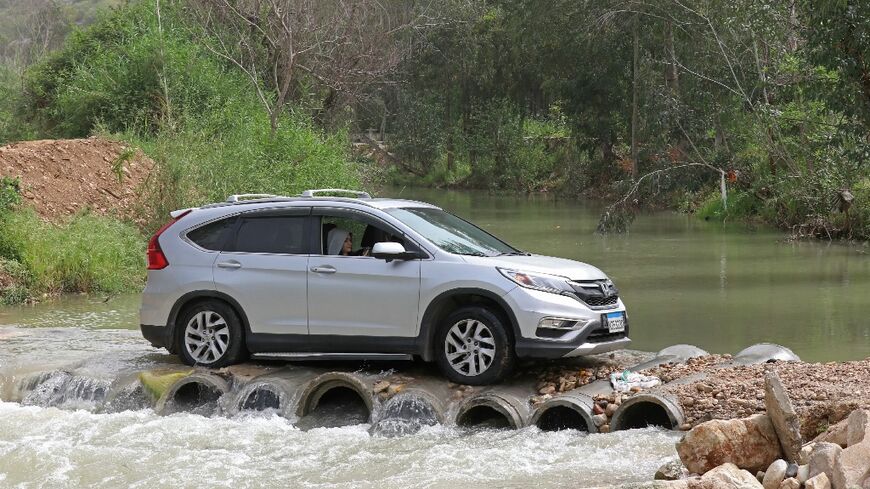 Displaced people drive back to their homes across the Litani river in southern Lebanon