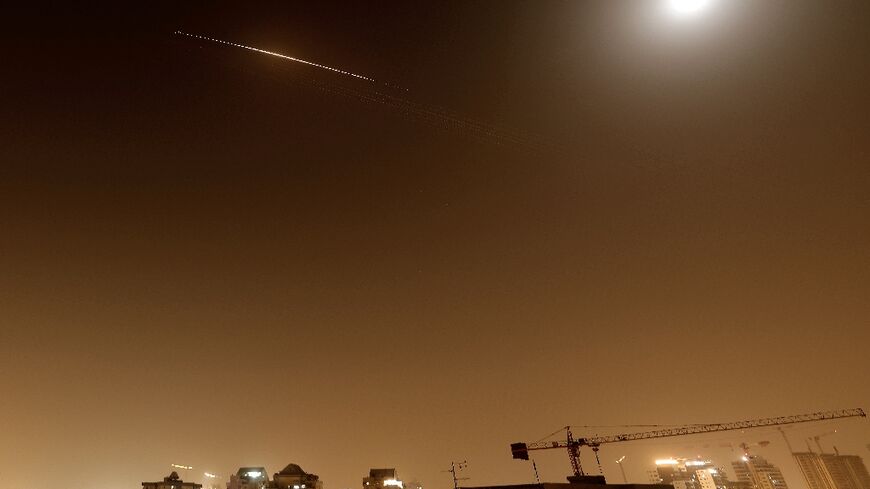 Rocket trails are seen in the sky above the Netanya, Israel, on April 4, 2026.