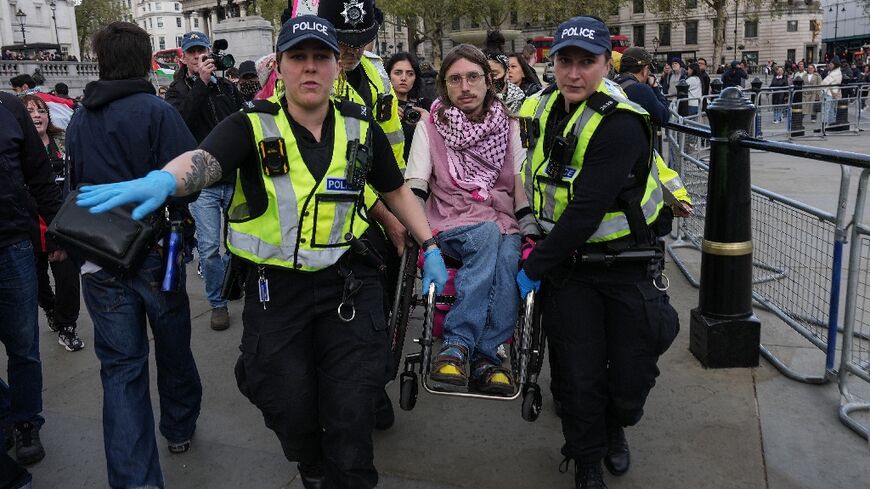 Officers carried away activists to cheers and clapping from other demonstrators at the sit-down demonstration