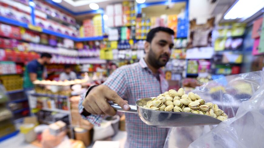 An Iranian grocer sells pistachios imported from Iran at a Persian products shop in the Gulf emirate of Dubai on July 10, 2019. (Photo by Karim SAHIB / AFP) (Photo credit should read KARIM SAHIB/AFP via Getty Images)