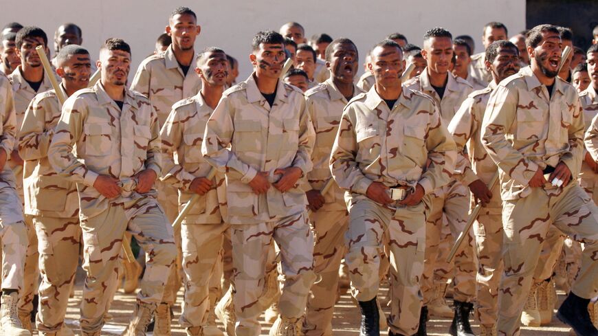 Cadets of the Saiqa Force (Special Forces) of the self-styled Libyan National Army affiliated with eastern strongman Khalifa Hifter take part in a graduation ceremony in tribute to the force's late commander, Wanis Bukhamada, in the eastern city of Benghazi, on Jan. 20, 2022. 
