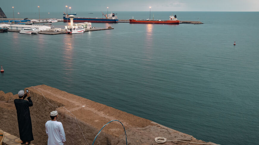 MUSCAT, OMAN - MARCH 25: Locals take photos of two bulk carriers anchored at Muscat Anchorage on March 25, 2026 in Muscat, Oman. Maritime traffic through the Strait of Hormuz, which conveys about 20% of the world's oil and gas, has mostly come to a halt after the joint U.S.-Israeli war with Iran that began on February 28. Iran, in a defiant reply to a ceasefire proposal from the United States, has claimed that sovereignty over the Strait of Hormuz "is its natural and legal right." Under international law, t