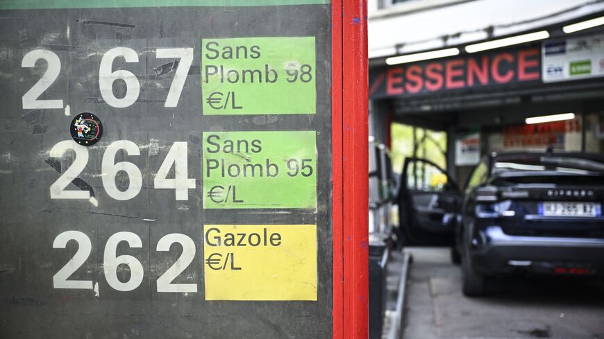 This photograph shows a sign displaying the daily price panel for SP98, SP95 and diesel at a gas station in Paris on April 2, 2026. 