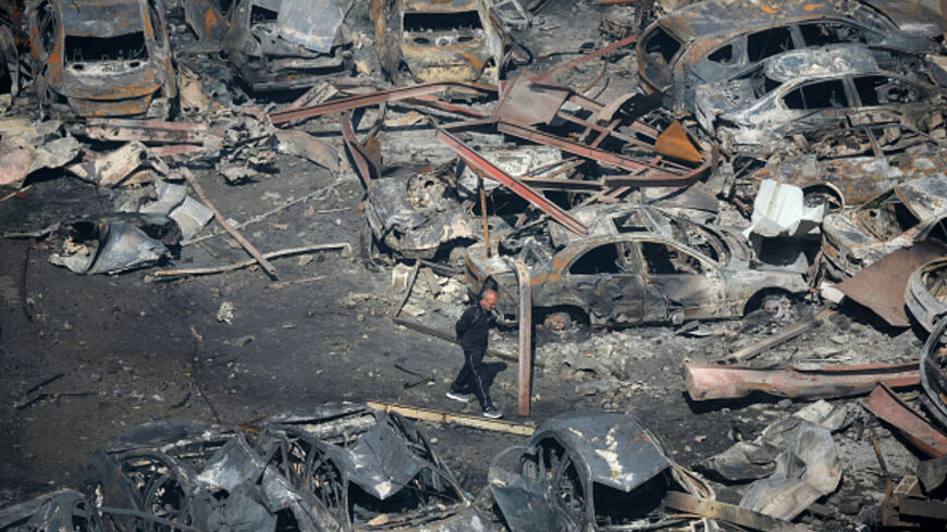 A Lebanese man walks amid charred cars at the site of an Israeli airstrike that targeted a building the day before in Beirut's Corniche al-Mazraa neighbourhood on April 9, 2026. (Ibrahim AMRO / AFP via Getty Images)