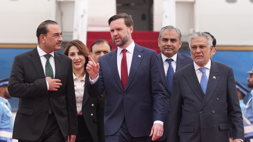 US Vice President JD Vance (C) walks with Pakistan's Chief of Defense Forces and Chief of Army Staff Field Marshall Asim Munir (L), and Pakistani Deputy Prime Minister and Foreign Minister Mohammad Ishaq Dar after arriving for talks with Iranian officials on April 11, 2026, in Islamabad, Pakistan. 