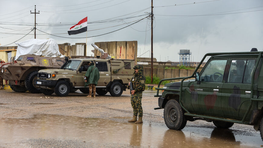 Members of Iraq's security forces stand guard on the the al-Rabia border crossing with Syria on April 20, 2026. 