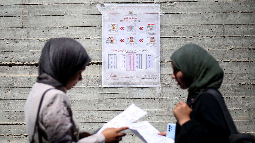Women read instructions to voters ahead of the upcoming municipal elections in Deir el-Balah in the central Gaza Strip on April 21, 2026. 