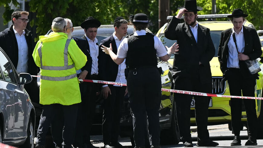 Local residents look on from outside a cordoned off area in the Golders Green neighborhood of north London on April 29, 2026, following the stabbing to two people nearby.