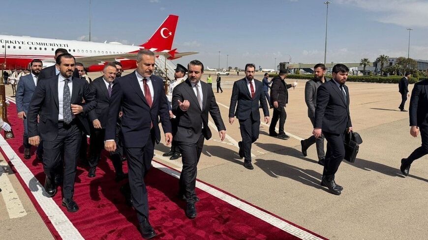 Turkish Foreign Minister Hakan Fidan walks alongside his Syrian counterpart, Asaad Shibani, as he arrives in Damascus, April 5, 2026.