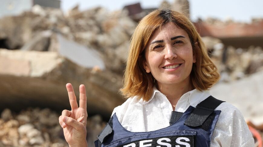 A photograph shows Amal Khalil, a veteran correspondent for the daily newspaper Al-Akhbar, in the southern Lebanese border village of Jebbayn in 2024