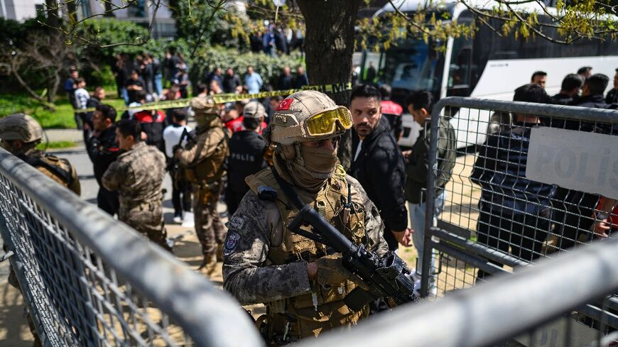 A police officer stands guard outside the Israeli consulate in Istanbul after the shootout