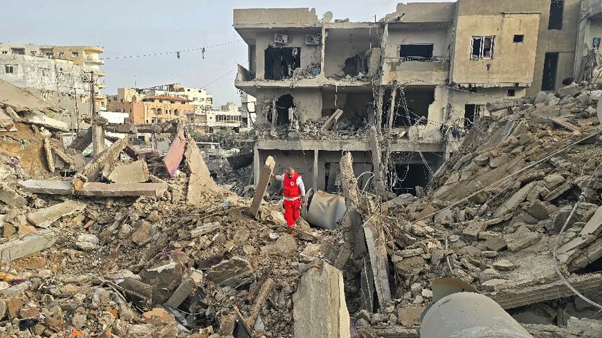 A rescue worker inspects the debris of destroyed buildings in the Maarakeh area near Tyre