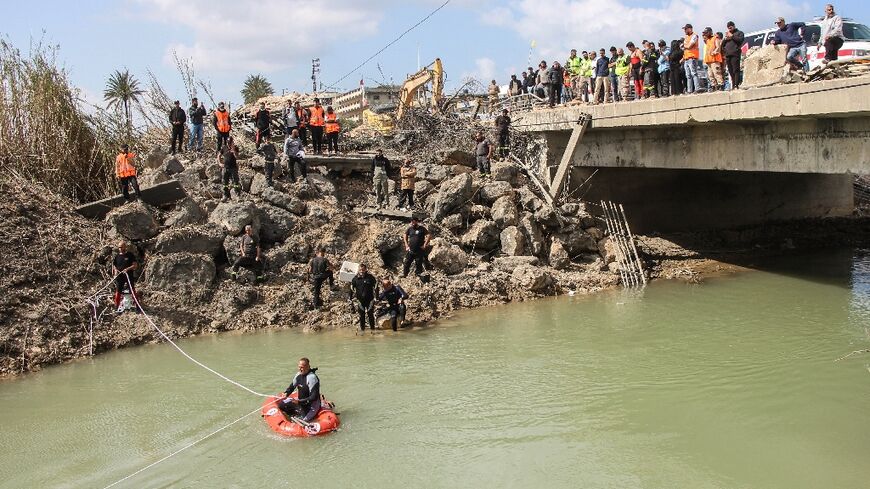 Lebanese rescuers personnel search for missing people in the river beneath the bomb-damaged Qasmiyeh bridge near the southern city of Tyre