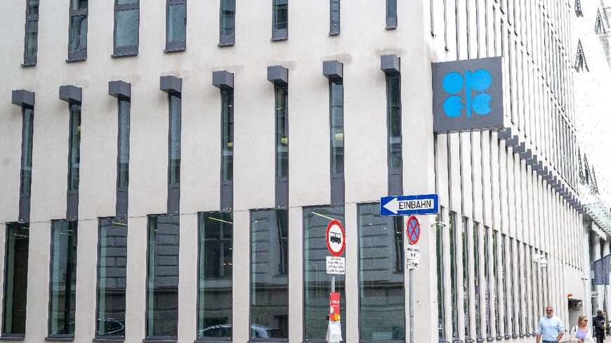 (FILES) People walk by the building headquarters of OPEC (Organization of The Petroleum Exporting Countries) as the logo is seen on its facade in Vienna, Austria