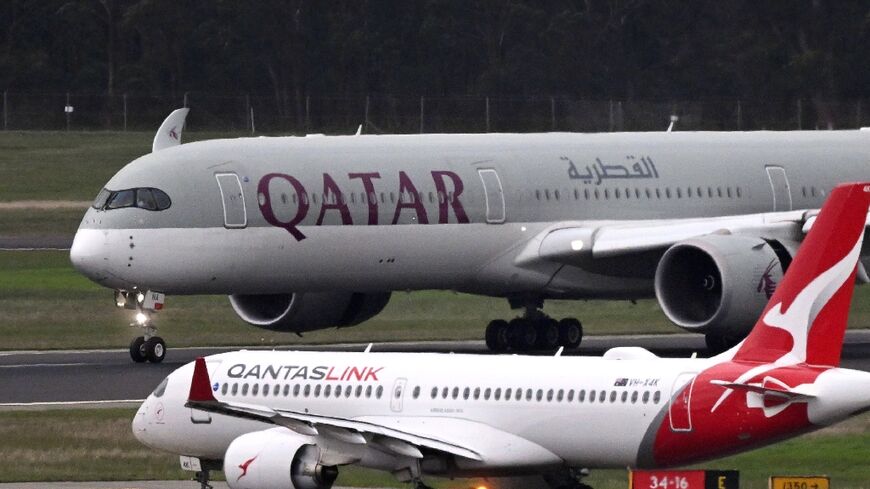 A Qatar Airways plane carrying Australians linked to suspected IS jihadists lands in Melbourne