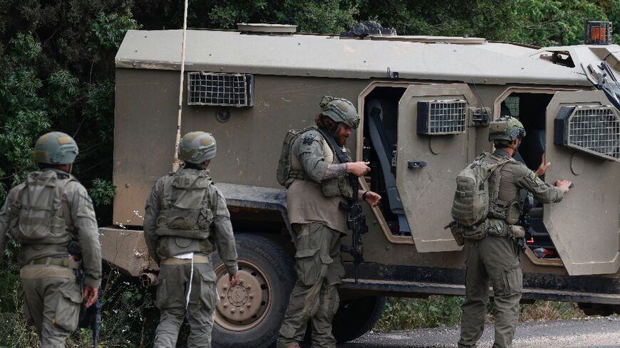 Israeli soldiers took cover near the Israel-Lebanon border following a Hezbollah drone attack