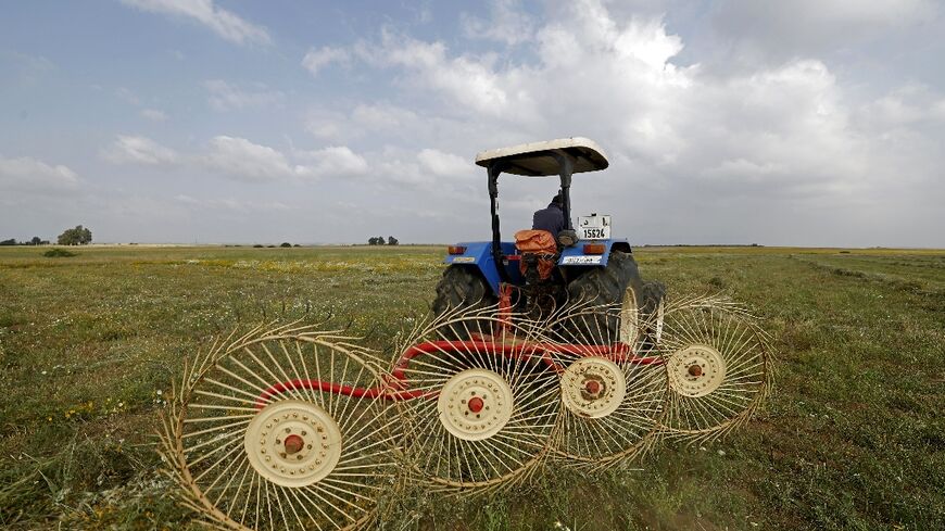 A farmer uses a hay-collecting machine in a field in the Zehiliga region of Morocco. Rising fertiliser costs are threatening the livelihoods of many farmers